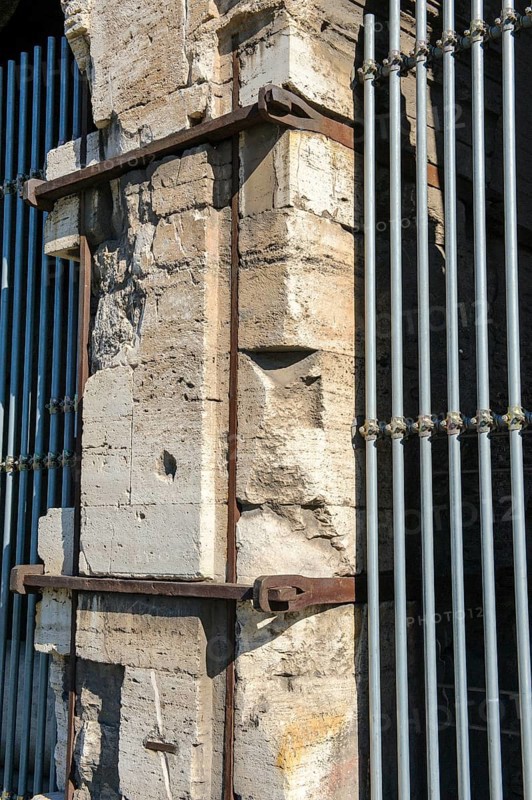 Pillar element made of travertine stone from Colosseum with architectural measure used in the construction of Amphiteatrum Flavium iron clips in masonry for stability strength cohesion, Rome, Lazio, Italy