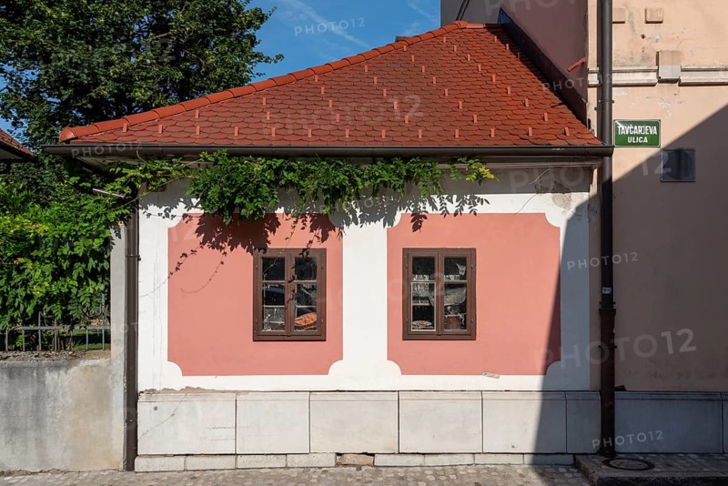 Pink house facade, window with old objects, Kranj, Upper Carniola, Slovenia