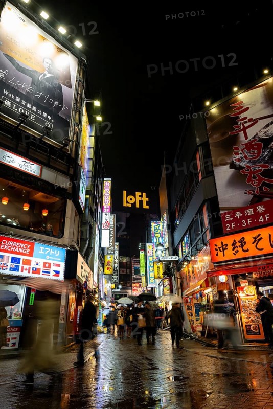 Busy pedestrian zone with many shopping centers and stores, illuminated with lots of neon signs at night, Shibuya, Udagawacho, Tokyo, Japan