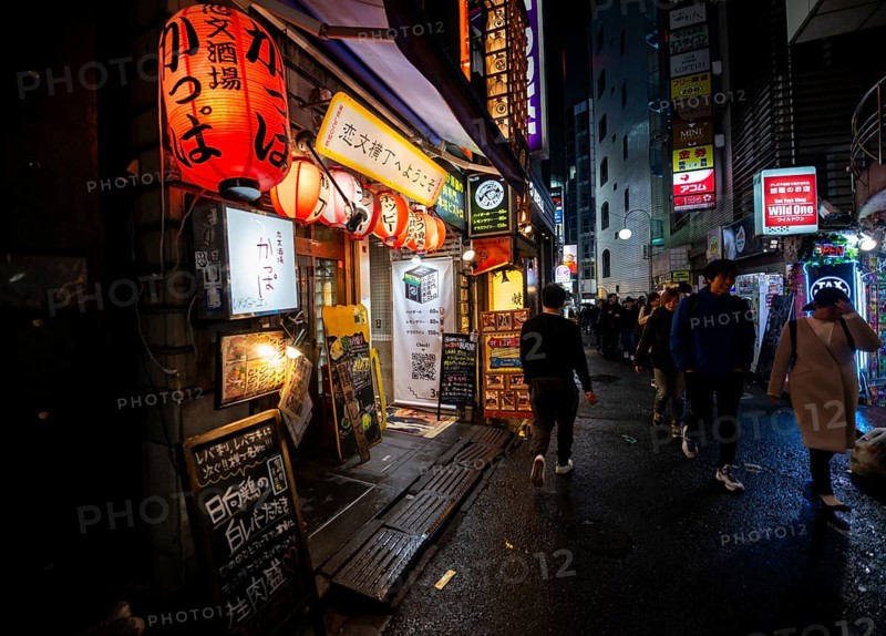 Pedestrians, alley with neon signs, paper lanterns and advertising signs at night, Udagawacho, Shibuya, Tokyo, Japan