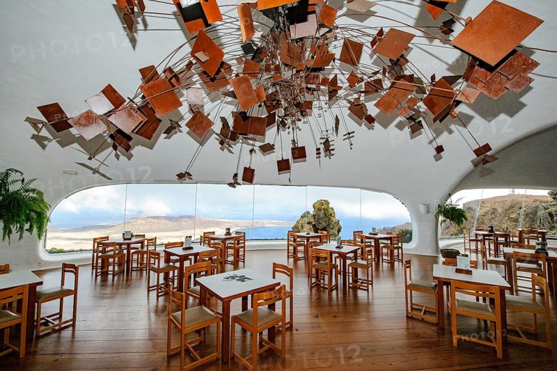 Interior of café with panoramic window in building designed by Cesar Manrique with the collaboration of Jesús Soto and architect Eduardo Caceres without right angles corners on viewpoint tourist attraction El Mirador del Río on the summit of the 474 meter high Risco de Famara in Famaramassiv with panoramic view of the Chinijo Archipelago, La Graciosa island, Lanzarote, Canary Islands, Canary Islands, Spain