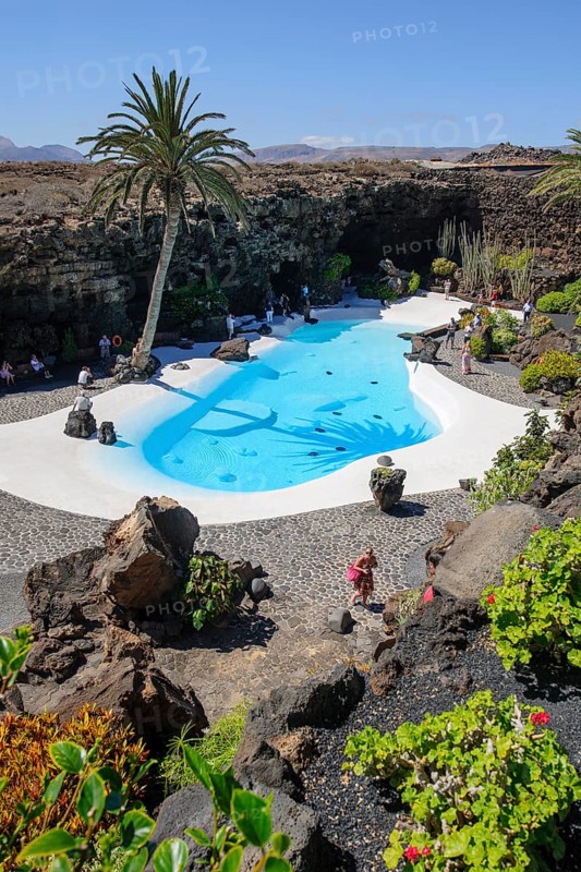 View from elevated position of pool designed by César Manrique Swimming pool in art venue cultural center tourist attraction Jameos del Agua, Punta Mujeres, Lanzarote, Canary Islands, Spain