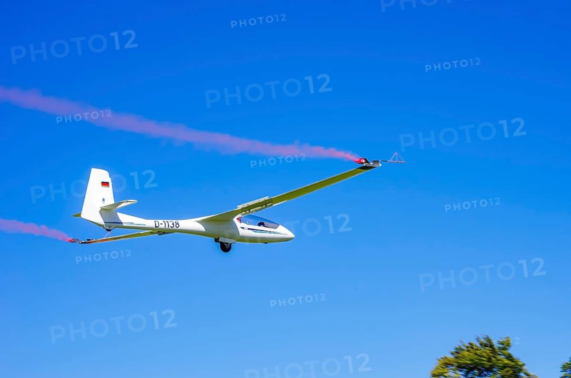 An SZD-59-1 ACRO glider, registration D-1138, during a demonstration as part of an air show at the Fliegerbergfest of the Rossfeld Luftsportverein in Metzingen-Glems, Baden-Württemberg, Germany, for editorial use only
