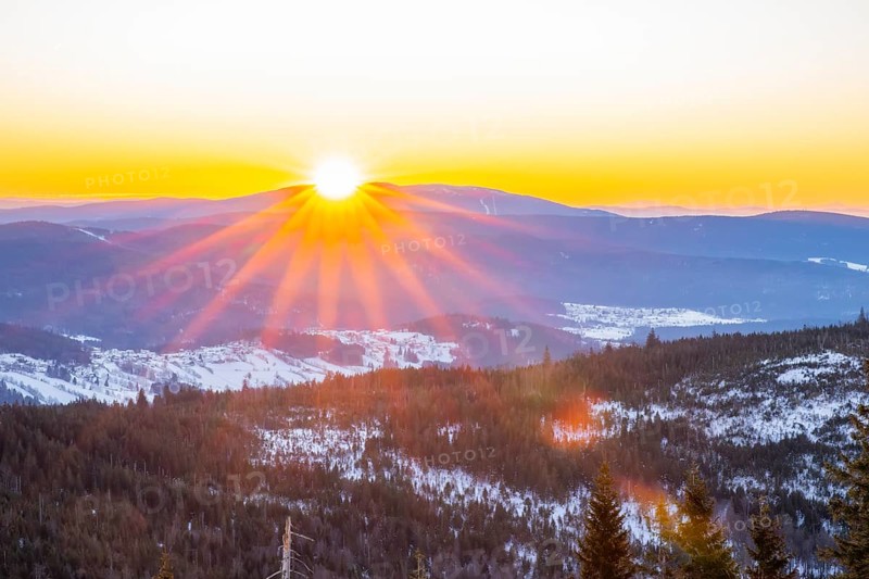 Sunrise over the hills of czech republic from Mount Lusen wth the view over the hills of the bavarian forest in winter, Bavaria, Germany