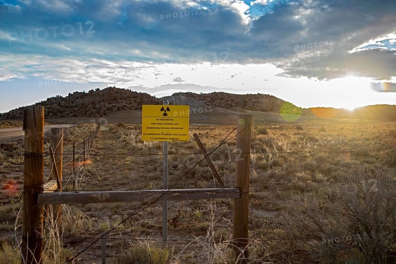 Jeffrey City, Wyoming - The sun rises behind a 'No Trespassing' signs which adorns the perimeter of a former uranium mine and mill which operated from 1957 until 1981. Uranium tailings and other radioactive debris have been buried and the site is now under the care of the Department of Energy