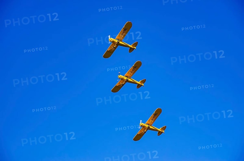Three Piper PA-18 Super Cub aircraft from the Bravo Lima Formation flying group in formation flight during a flight demonstration at the Rossfeld Air Sports Club Air Sports Association on Rossfeld in Metzingen-Glems, Baden-Württemberg, Germany, for editorial use only