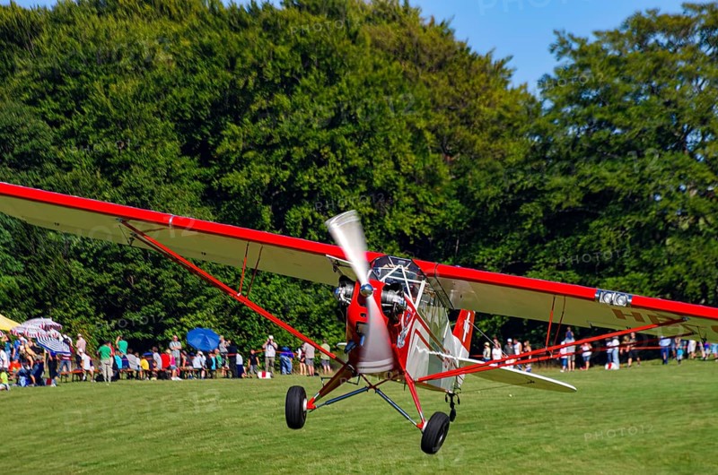 A Piper J-3C/L4 Cub light aircraft, HB-OBF registration, during a flight demonstration as part of an air show on Rossfeld in Metzingen-Glems, Baden-Württemberg, Germany, for editorial use only