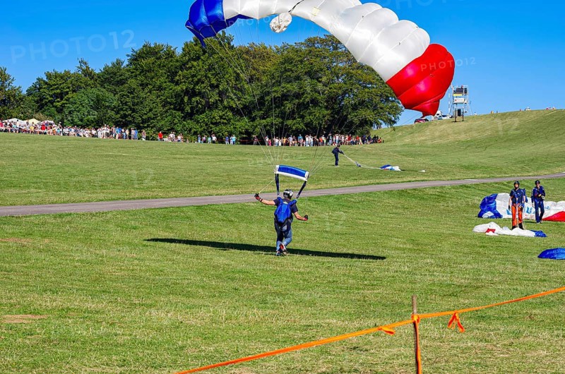 Landing of skydivers during an aerial acrobatic performance as part of an air show at the Rossfeld Air Sports Association Air Sports Festival on Rossfeld in Metzingen-Glems, Baden-Württemberg, Germany, for editorial use only