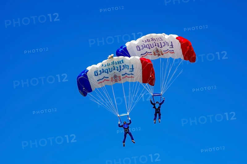 Skydivers during an aerial acrobatic performance as part of an air show at the Fliegerbergfest of the Rossfeld Luftsportverein in Metzingen-Glems, Baden-Württemberg, Germany, for editorial use only