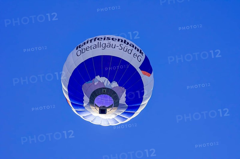 A hot air balloon, registration D-OASF, rises into the air as part of an air show at the Fliegerbergfest of the Rossfeld Luftsportverein in Metzingen-Glems, Baden-Württemberg, Germany, for editorial use only