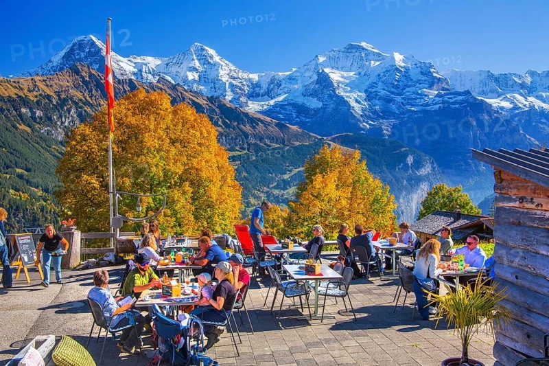 Sun terrace of the mountain inn in the hamlet of Sulwald with Eiger 3967m, Mönch 4110m and Jungfrau 4158m in autumn, Isenfluh, Lauterbrunnental, Bernese Oberland, Canton of Bern, Switzerland