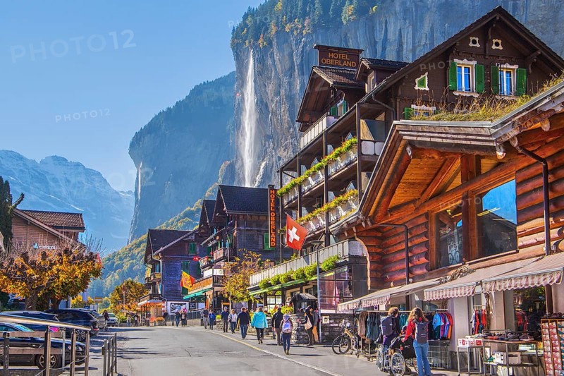 Village road with Staubbach waterfall, Lauterbrunnen, Bernese Oberland, Canton of Bern, Switzerland