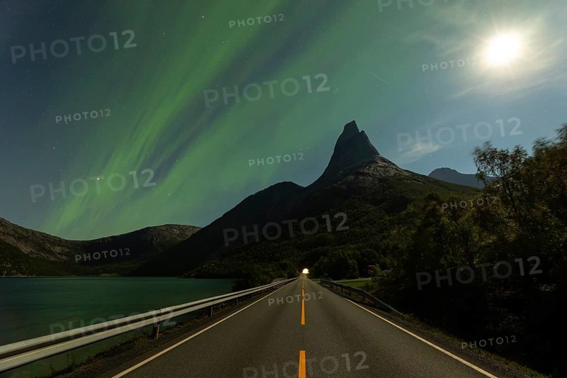 Magical Stetind mountain in northern Norway under auroras and full moon