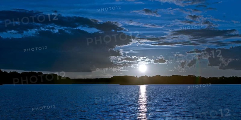 Atmospheric moonrise over Lake Gudelack, Lindow (Mark), Stechlin-Ruppiner Land nature park Park, Brandenburg, Germany