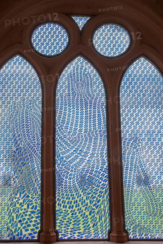 Colourful stained glass window with geometric patterns, the Pietà window by Thomas Bayrle, in the cloister of Eberbach Abbey, former Cistercian Abbey, Eltville, Rheingau, Hesse, Germany