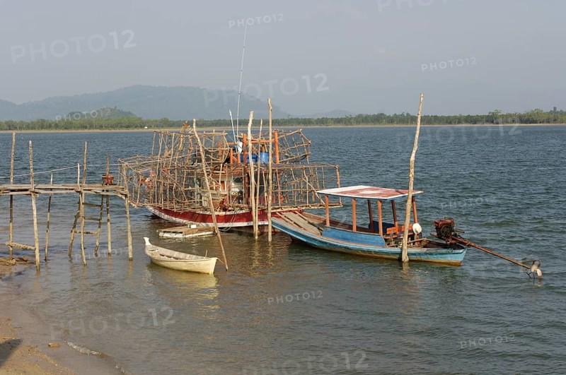 Small fishing boat on the right, boat on it lots of large bamboo traps, Phang Nga Phang-nga province, Thailand