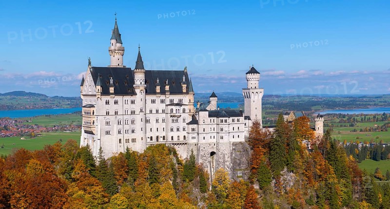 A detailed view of Neuschwanstein Castle with autumn colors and wide fields in the background, Schwangau, Königswinkel, Ostallgäu, Allgäu, Swabia, Bavaria, Germany