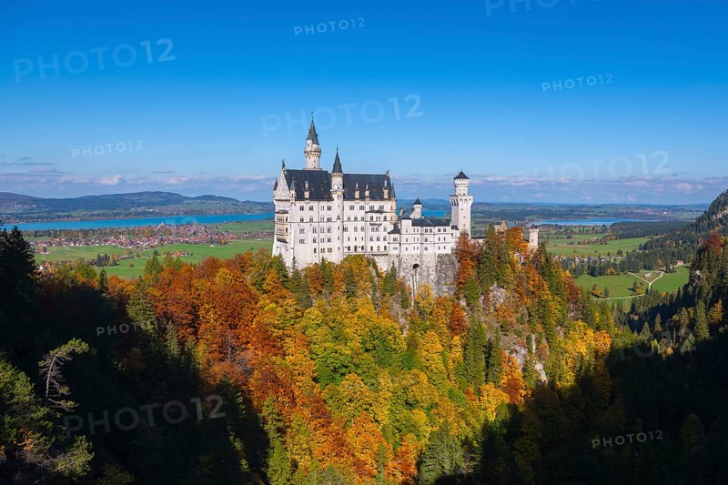 The fairytale Neuschwanstein Castle with autumn trees and views of the surrounding countryside, Schwangau, Königswinkel, Ostallgäu, Allgäu, Swabia, Bavaria, Germany