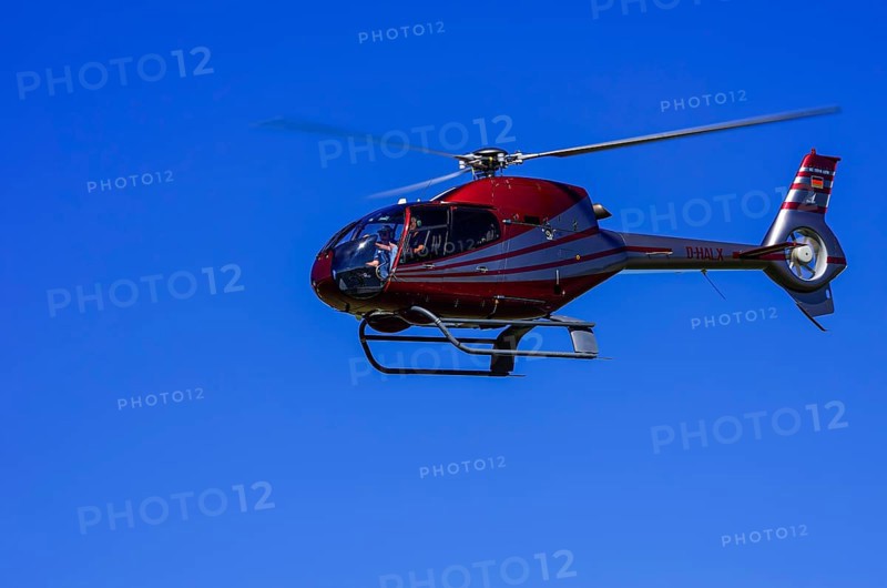 A Eurocopter EC 120B Colibri helicopter, D-HALX registration, during a flight demonstration as part of an air show on Rossfeld in Metzingen-Glems, Baden-Württemberg, Germany, for editorial use only