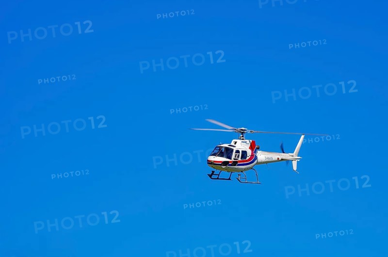 An Aerospatiale AS-350 BA Ecureuil helicopter, registration D-HAAN, from Meravo Air Company during a flight demonstration as part of an air show on Rossfeld in Metzingen-Glems, Baden-Württemberg, Germany, for editorial use only