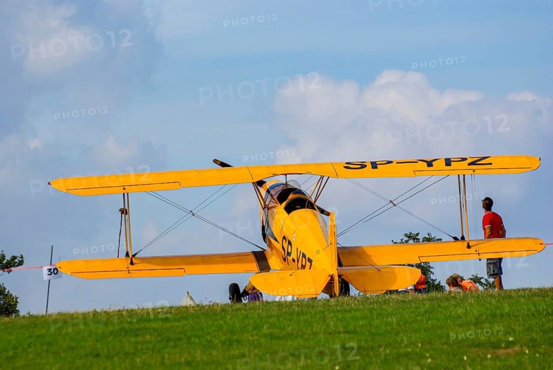 A Bücker Bü 131 Jungmann biplane parked at the edge of the airfield, SP-YPZ registration, as part of an air show on Rossfeld in Metzingen-Glems, Baden-Württemberg, Germany, for editorial use only