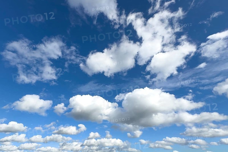White clouds in the middle and below Cumulus above Stratocumulus loose cloudiness cloudy against blue cloudy sky, international