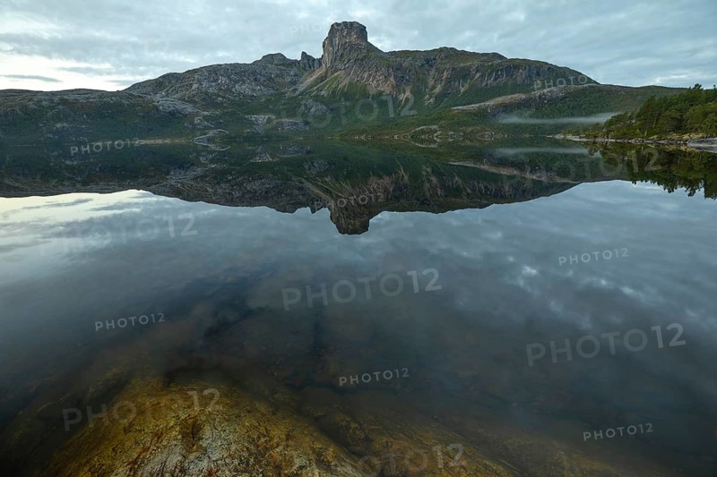 Morning dream over the quiet Steigtindvatnet near Bodø. The mountain is reflected in the lake