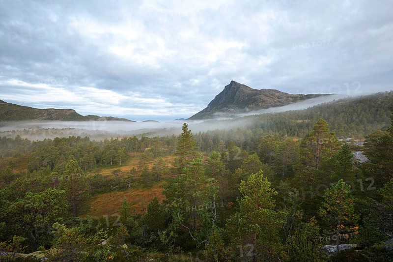 Magical morning fog on Steigtindvatnet in front of the majestic Litltind in Norway near Bodø