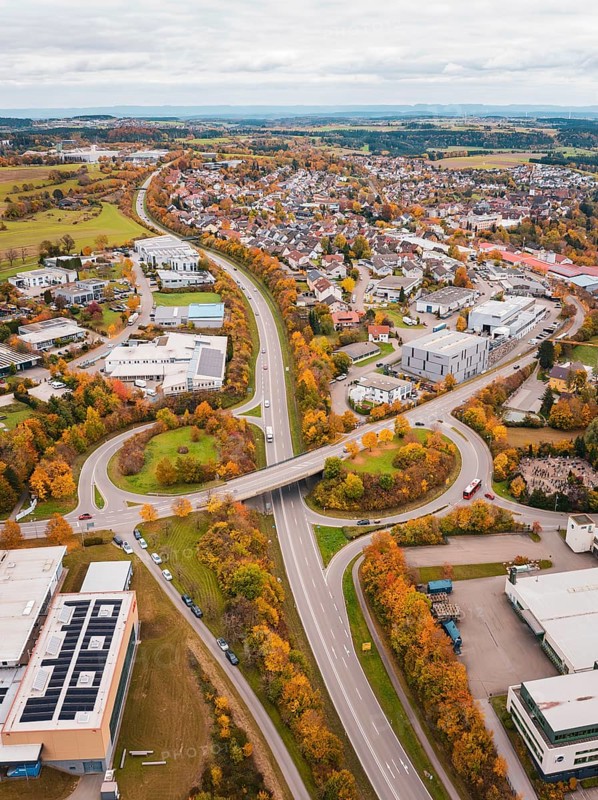 Urban area with roads and buildings in autumn colors seen from a bird's eye view, Dornstetten, Freudenstadt district, Germany