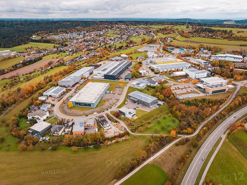 Extensive industrial area with autumn trees and buildings seen from an aerial perspective, Dornstetten, Freudenstadt district, Germany