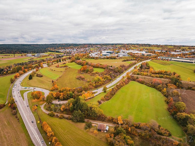 Wide landscape with winding roads, meadows and autumn atmosphere under cloudy sky, Dornstetten, Freudenstadt district, Germany