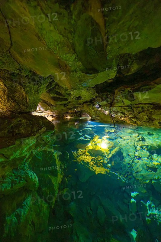 Scenario in a cave with crystal clear water and impressive rock walls, Wimsener Höhle, Hayingen, Germany