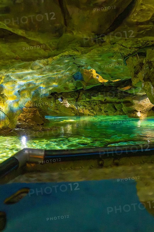 Underground scenario in a cave with shimmering green water and dramatic lighting, Wimsener Höhle, Hayingen, Germany
