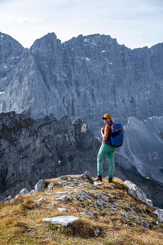 Female hiker on hiking trail, hiking to Gamsjoch, behind Dreizinkenspitze and Laliederer Wand, eastern Karwendel, Tyrol, Austria