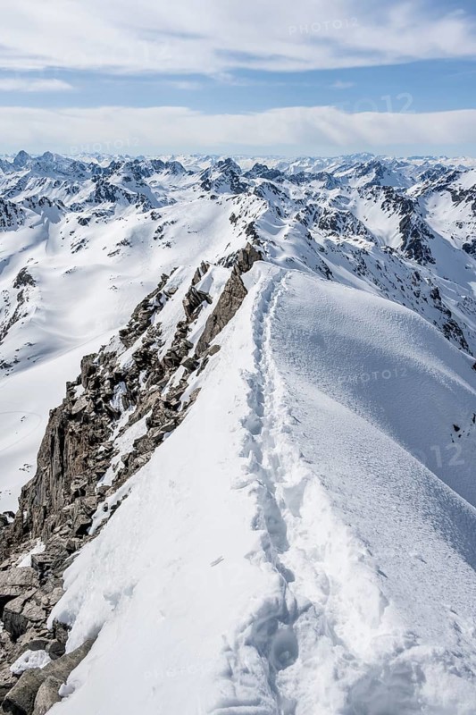 Narrow mountain ridge in winter, summit of Piz Grialetsch, view of mountain panorama with snow, Bündner Haute Route, Albula Alps, Rhaetian Alps, Grisons, Switzerland