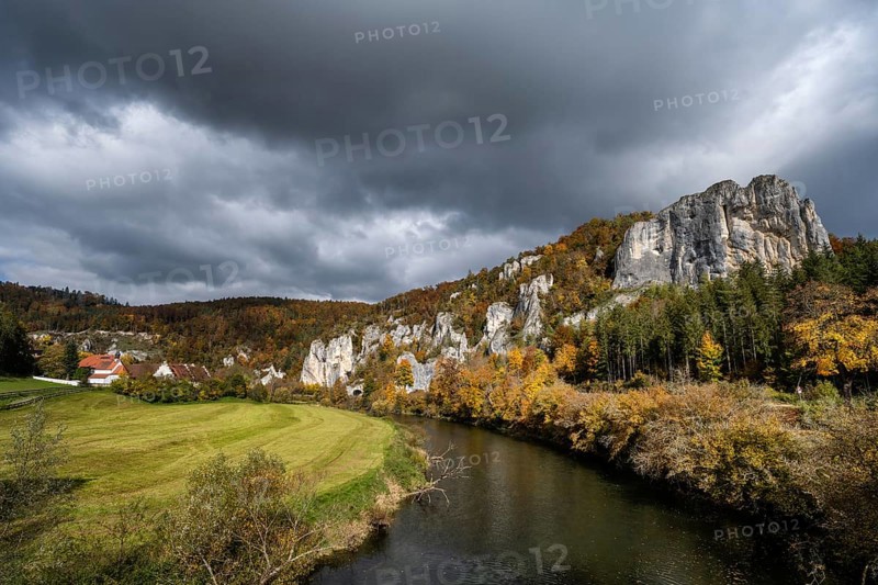 View of the Danube, surrounded by autumn vegetation, on the left the Käppeler estate with the St. George's Basilica, on the right the Raven Rock, Sigmaringen district, Baden-Württemberg, Germany