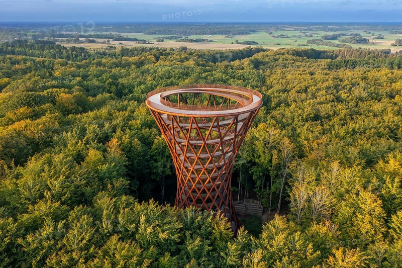 Aerial view over 45-meter-tall hyperboloid observation tower in forest near Gisselfeld monastery at Haslev on Zealand island in late summer, Denmark
