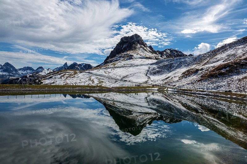 Kanzelwand is reflected in the reservoir, Kanzelwand snow-making pond, mountains of the Allgäu Alps behind, Vorarlberg, Austria