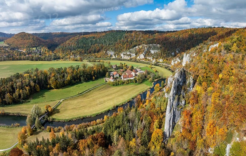 Aerial view, panorama of Käppeler estate with the St. George's Basilica near Thiergarten in the upper Danube Valley, surrounded by autumn vegetation, on the right the raven rocks, climbing rocks, Jura limestone rocks, Sigmaringen district, Baden-Württemberg, Germany