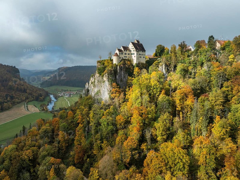 Aerial view of Werenwag Castle and former Werenwag Castle on a rocky spur in the Upper Danube Valley, surrounded by autumnal vegetation and clouds of fog, Sigmaringen district, Baden-Württemberg, Germany
