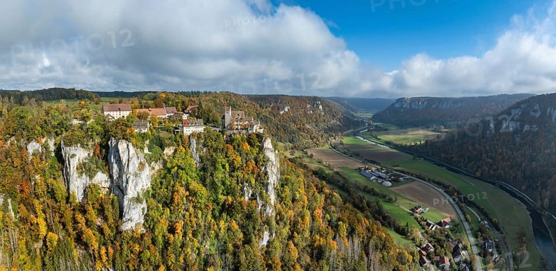 Aerial view, panorama of Werenwag castle and former castle on a rocky spur in the upper Danube Valley, surrounded by autumnal vegetation and clouds of fog, Sigmaringen district, Baden-Württemberg, Germany