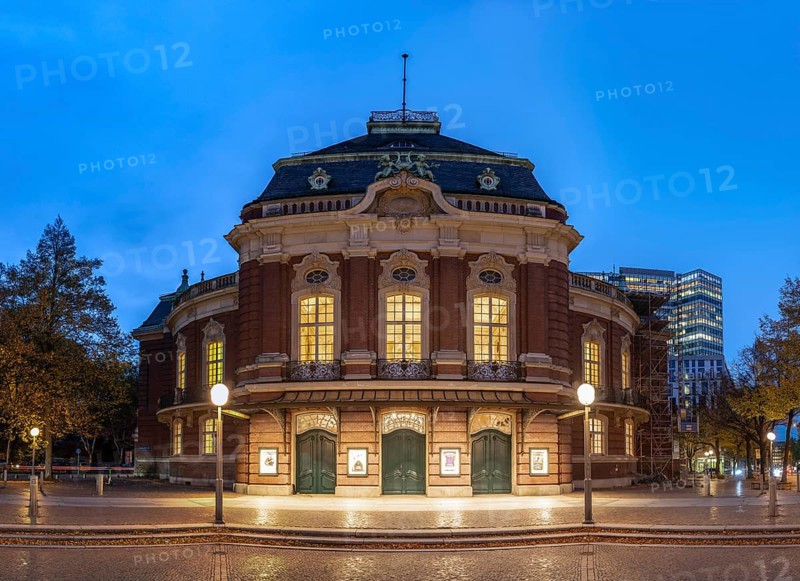Laeiszhalle, formerly Musikhalle Hamburg, at Johannes Brahms Platz at Blue Hour with light clouds in the background and street lights in the foreground, Hamburg, Germany