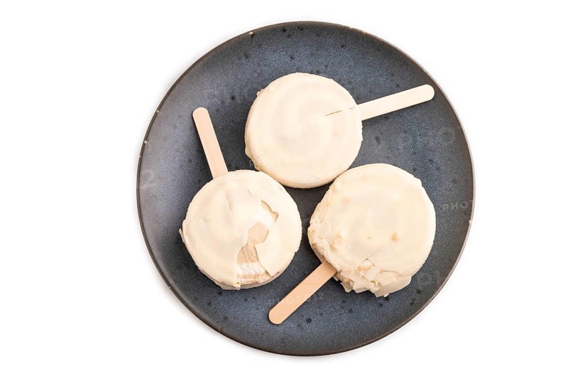 ?hocolate Ice cream in white glaze isolated on white background, top view, flat lay, close up, minimalism