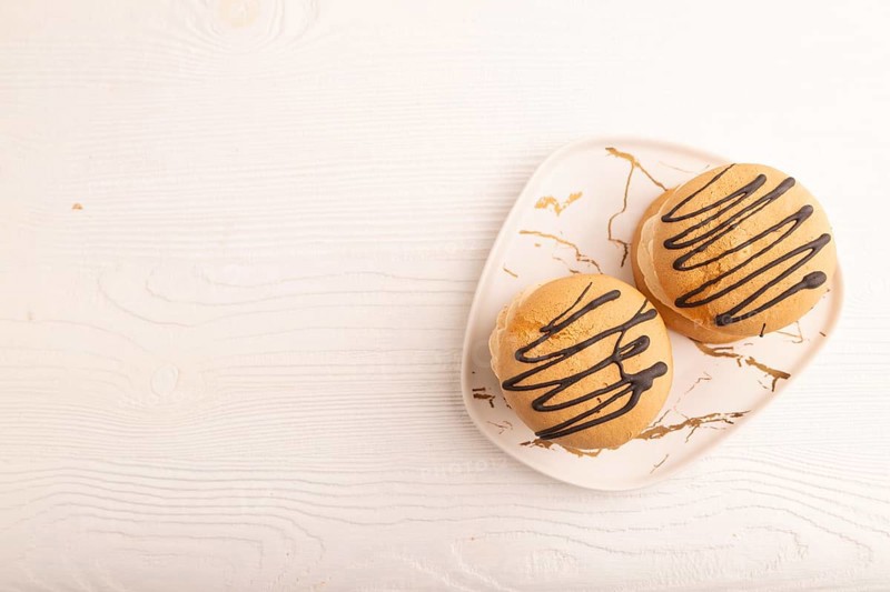 Caramel Cream Cakes on white wooden background, top view, flat lay, copy space