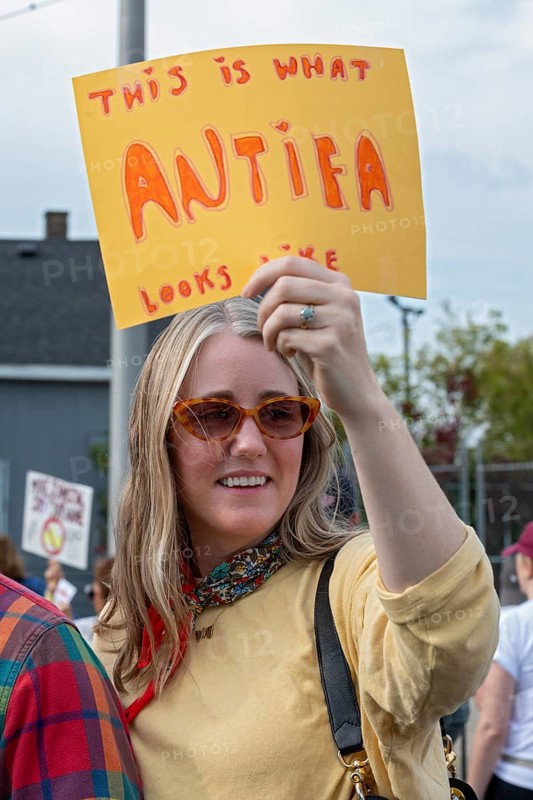 Detroit, Michigan USA - 18 October 2025 - Protesters from Detroit and Grosse Pointe gathered on the border between their cities for a 'No Kings' rally, protesting President Trump's actions against immigrants and against democratic institutions