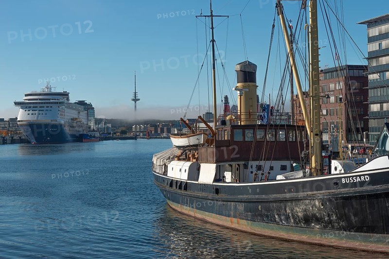 Kiel harbor, Seegarten museum bridge with historic buzzard from 1906, chimney, crane, Kiel-Oslo ferry on the east shore quay, ferry and crusader of the Color Line, radio tower, haze bell, blue sky, sunshine, Kiel Fjord, Baltic Sea, Schleswig-Holstein, Germany