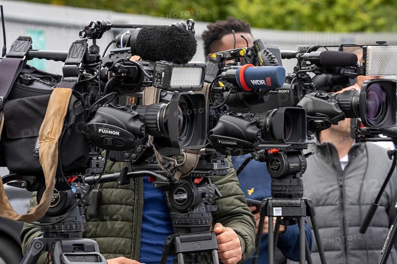 Camera crews, TV teams from various radio stations, television stations, film at a press conference