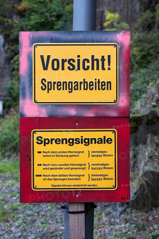Information board about blasting work at a construction site, explosive signals, here near Altenahr, Rhineland-Palatinate