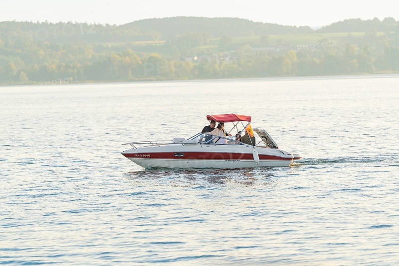 A motorboat with people enjoying a relaxing trip on a quiet lake, Überlingen, Lake Constance, Germany