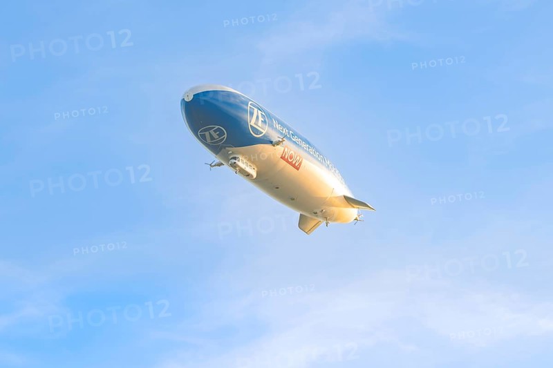 Zeppelin under a clear, cloudless sky, carrying an advertising message, Überlingen, Lake Constance, Germany